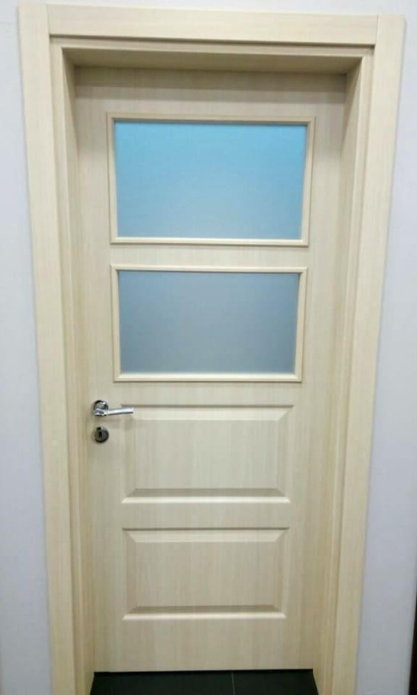 Awooden intrior door with a two frosted glass panel s