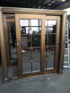 bronze-coloured Turkish door with decortive cast elements and a sliding glass panels