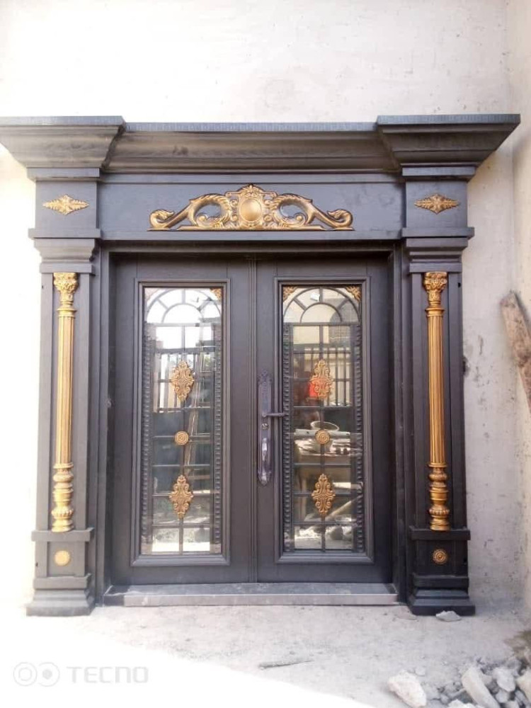 Luxury Security Door featuring a dark finish and gold-toned decorative accents