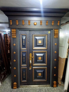 Cast Aluminum Security Door with an imitation copper/bronze finish and decorative arl and pillar frame