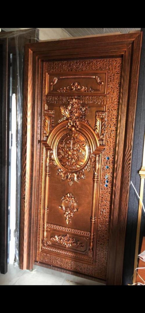 This is a Luxury copper alloy Security Door with a decorative relief design and a wood-grain finish