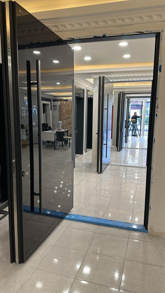 This is a modern Pivot door on display in a showroom