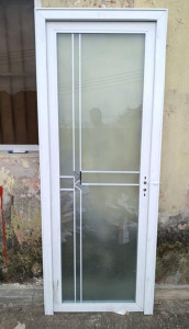 Aluminum-framed frosted glass door potentially for a bthroom or toilet 