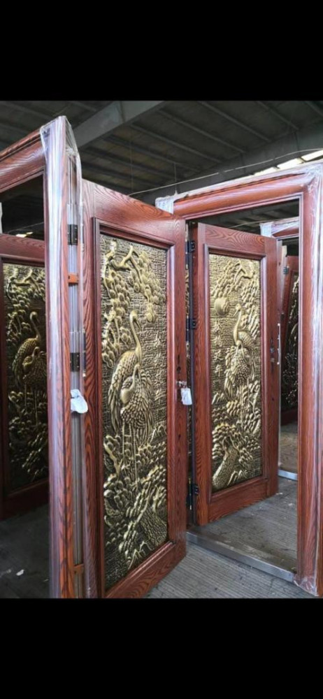 Cast copper Security Door with a raised crane and nature design