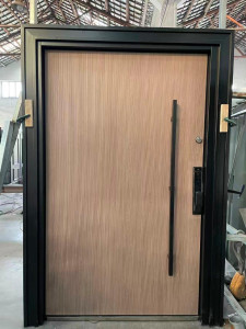 Modern main Entrance door features a teak wood laminate finish and a vertical black security lock handle
