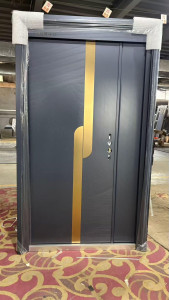 modern security door featuring a gray, textured finish with a prominent vertical gold-coloured handle accents