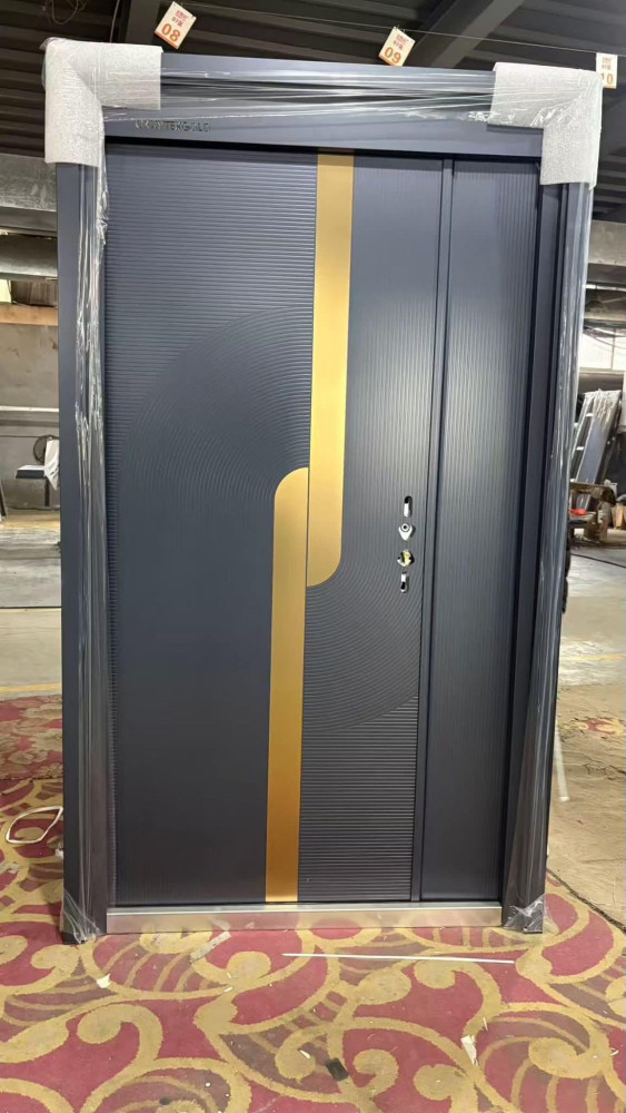 modern security door featuring a gray, textured finish with a prominent vertical gold-coloured handle accents