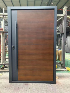 Modern Exterior Steel door features a wood-grain finish and a large vertical pull handle commonly referred to as pivot door