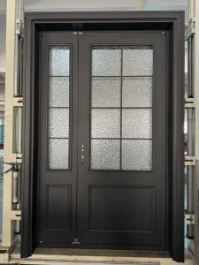 custom wrought iron entry door featuring a matte finish, large glass lites with a grid pattern, and privacy-focused aquatex